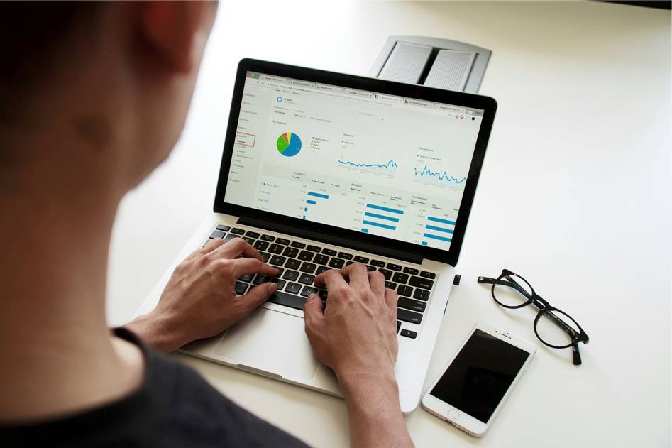 Two professionals reviewing marketing automation analytics on a tablet in a modern office setting